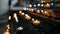 Burning candles in transparent chandeliers inside cathedral church