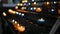 Burning candles in transparent chandeliers inside cathedral church