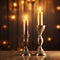 Burning candles in vintage candlesticks on dark background