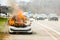 Burning car on fire on a highway road accident