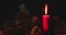 Burning Christmas candle on dark background
