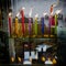 Burning, colorful wax Hanukkah candles reflected n a shiny marble surface.