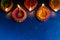 Burning decorated ceramic oil lamp diya, on Happy Diwali, Shubh Diwali meaning with beautiful dark blue background, copy