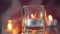 Burning decorative candle in glass candlestick