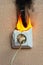 Burning electrical wiring and electrical outlet. Faulty wiring causes fires. Poor old wiring causes a fire in the electrical