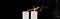 Burning and extinct white candles with smoke on black background, panoramic shot