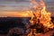 Burning fire hearth on a rocky mountain peak in the middle of the sahara desert