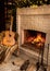 Burning fireplace. Beautiful fire, next to the chair with a guitar and a rug.