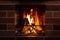 Burning fireplace, close up.  Cozy atmosphere autumn or winter evening. Open fire with real flames firewood burning in fireplace