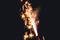 Burning flare or flame with bright sparks and smoke from a burnt candle on background with copy space. festive event concept