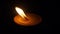 Burning flat candle at night isolated on dark background