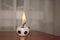 Burning football candle. Football fire.