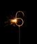 Burning golden sparkler in shape of number six, digit 6, isolated on black