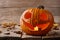 Burning Halloween pumpkin on wooden planks