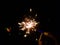 Burning of hand held sparkle firework in black background