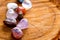 Burning incense cone with tumbled crystal stones on cross section of timber tree log