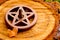 Burning incense cone in wooden pentacle incense holder on natur