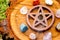 Burning incense cone in wooden pentacle incense holder on natur