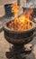 Burning incense sticks in old stone pot at Sacred Sri Maha Bhodi Gardens