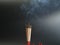 Burning incense white smoke black background used as a worship background image a sacred object of Buddhist beliefs focuses on the