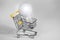 A burning light bulb in a shopping cart. A notion of energy saving