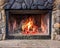 Burning logs in Winter fireplace for heat and warmth