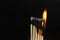 Burning matches on black background. matchsticks on fire in row of burning is sequence while one match stay down from burning to