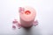 Burning pink wax candle and flowers isolated, above view