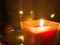 Burning red candle in a square glass candle with a yellow flame, winter romantic atmosphere, holidays, well-being