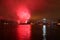 Burning red expolsion Fireworks Over Water San Diego, California Midway