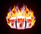 Burning slot machine wins wins the jackpot. Fire casino concept. Hot 777