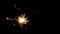 Burning sparkler or bengal light in darkness