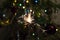 Burning Sparkler fire amid Christmas tree lights