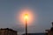 Burning street lamp against the sky. evening city