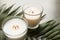 Burning wax candles and tropic leaf