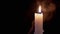 Burning White Paraffin Candle with a Bright Flame in a Smoky Room. Slow motion