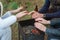 Burning wood in the grill and red coals with stream coming up from it. Little boy in red coat is warming his frozen hands above