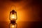 Burning yellow kerosene lamp background with reflection, concept lighting