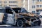 Burnt car in the courtyard of a multi-storey building to illustrate an article about a fire, banditry, an insured event, loss