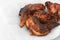 Burnt fried chicken wings on white tissue background  for reduced the cooking oil