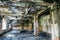 Burnt house interior. Burned room with columns, charred walls and ceiling in black soot