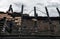 Burnt house roof with some tiles on it