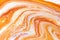 Burnt orange liquid and white foam mixing raster background. Colorful fluid splashes realistic illustration. Golden oil