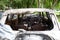Burnt-out passenger car, rear view. Fire completely destroyed the interior of car. Abandoned unattended transport. Selective focus