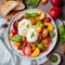 Burrata cheese salad with peaches, tomatoes, cranberries, basil and bruschetta slices on a gray background. Close up, top view.