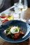 Burrata with paprika-truffle jam and cherry-cluster tomato salad. Delicious healthy Italian traditional food closeup