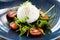 Burrata with paprika-truffle jam and cherry-cluster tomato salad. Delicious healthy Italian traditional food closeup