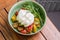 Burrata salad with cherry tomatoes, pesto and spices in a bowl