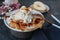 burrata is served with roasted caramelized pear and pine nuts. Close-up