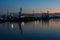 Burrgas Sea Port at night. Silhouettes of cranes and reflections in the water